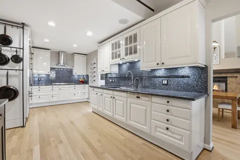 a kitchen with stainless steel appliances kitchen island granite countertop a refrigerator and a stove top oven