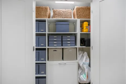 a view of a hallway with wooden floor and a living room