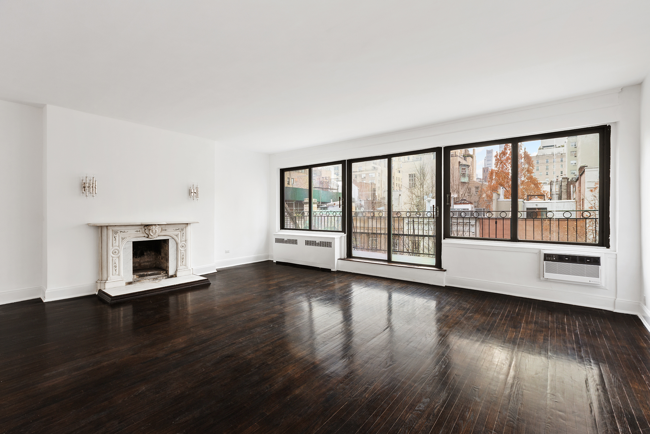 7 East 74th Street, Unit PH Manhattan, NY 10021 - Photo 4 of 10 a view of an empty room with wooden floor and a window