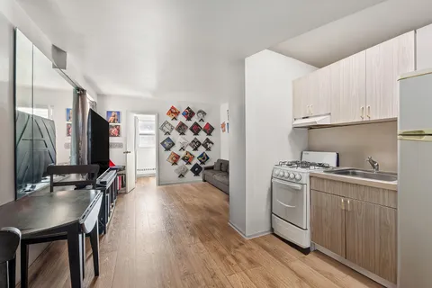 a kitchen with granite countertop a sink appliances and cabinets