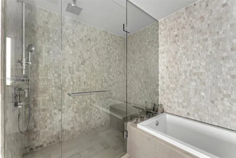 a bathroom with a bathtub and a shower