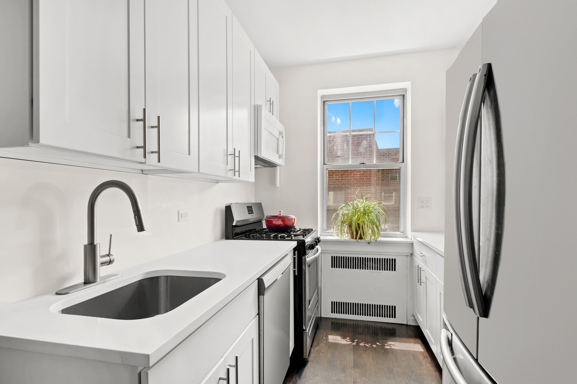 720 Fort Washington Avenue, Unit 6D Manhattan, NY 10040 - Photo 3 of 7 a kitchen with a sink cabinets and stainless steel appliances