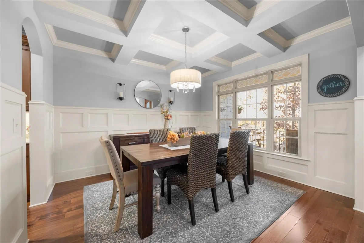 a living room with furniture kitchen view and a chandelier