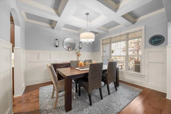 a living room with furniture kitchen view and a chandelier
