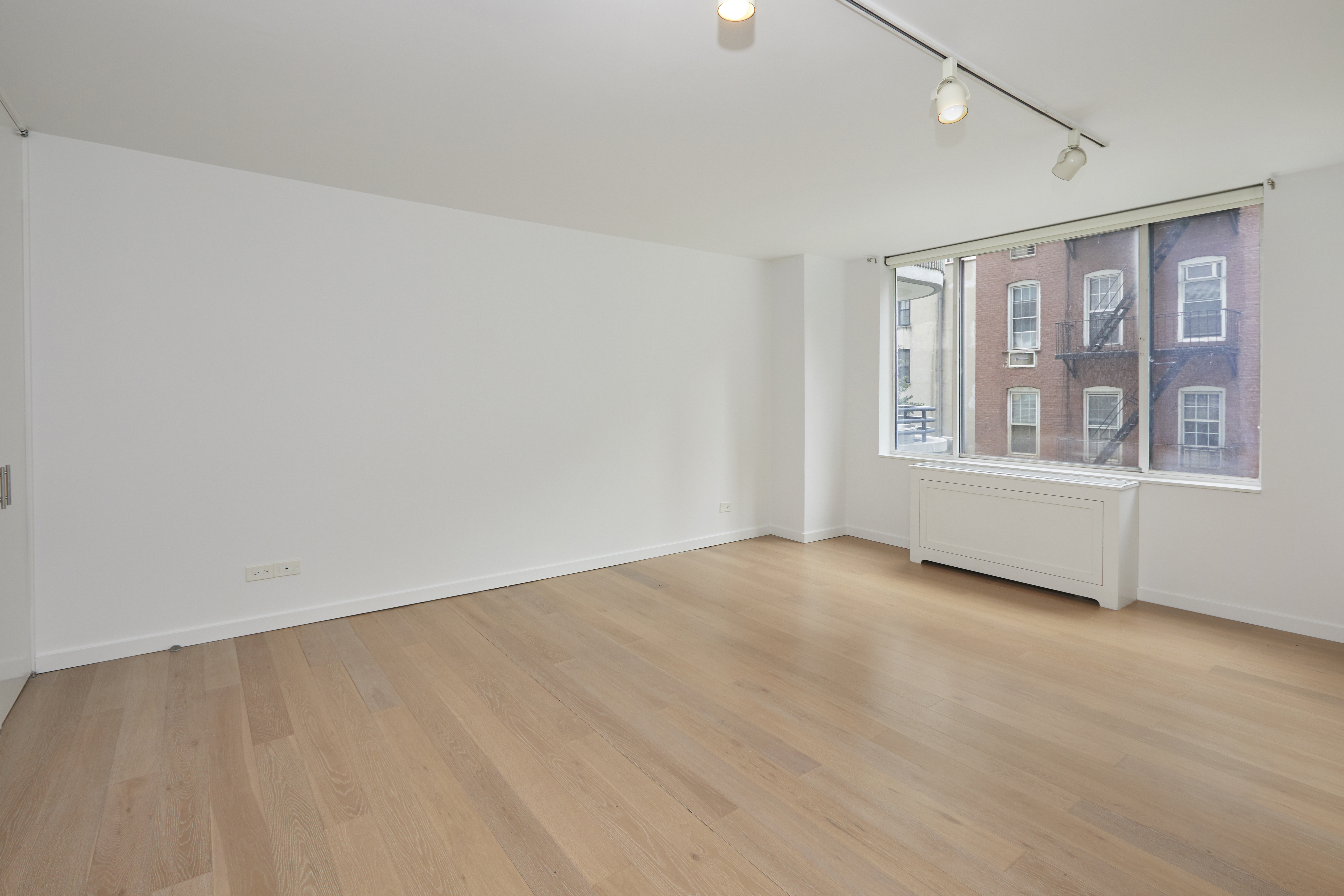 309 East 49th Street, Unit 3D Manhattan, NY 10017 - Photo 6 of 11 a view of an empty room with a window
