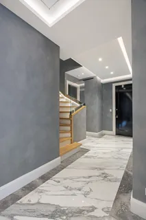 a view of a livingroom with wooden floor and staircase