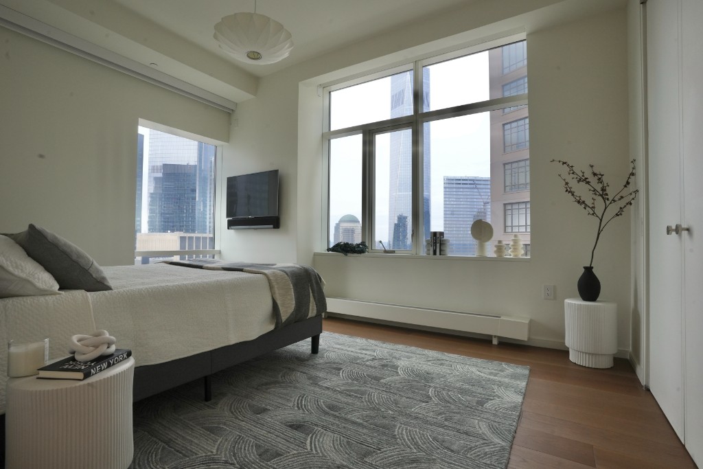 5 Beekman Street, Unit 43A Manhattan, NY 10038 - Photo 12 of 33 a bedroom with a bed and a large window