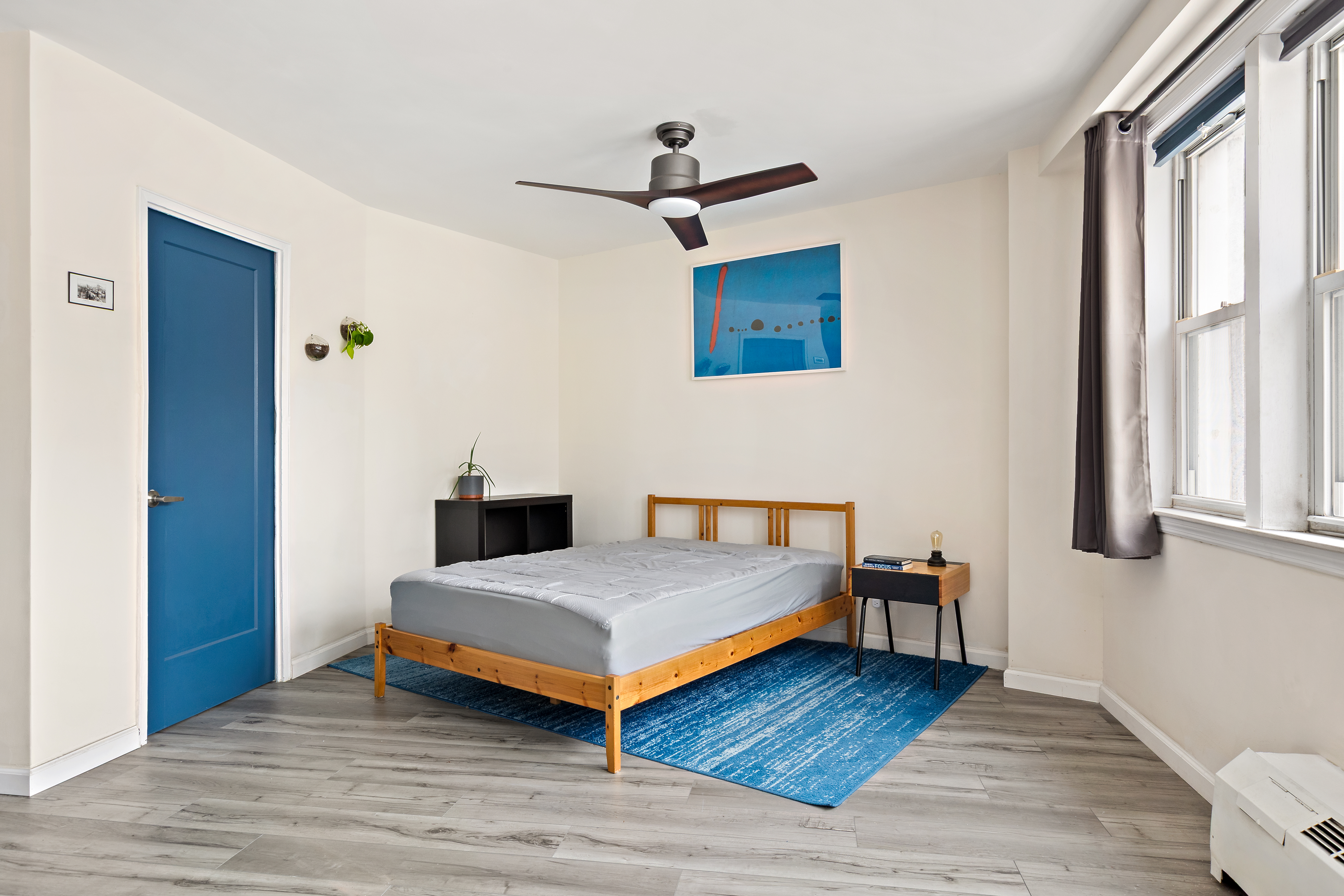 1655 Flatbush Avenue, Unit B210 Brooklyn, NY 11210 - Photo 4 of 5 a bedroom with a bed and wooden floor