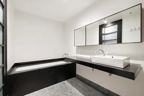 a kitchen with a sink and a mirror