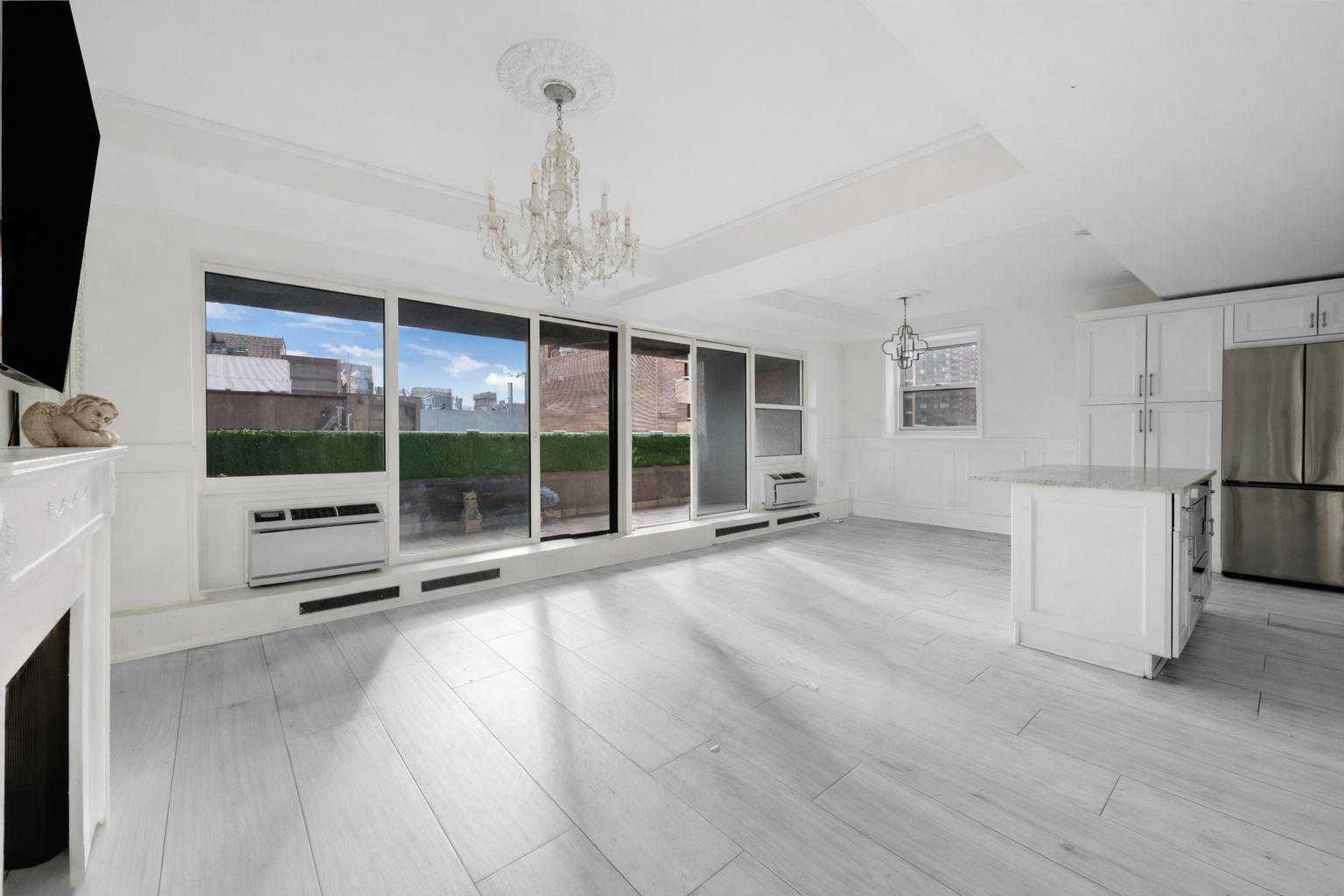 350 East 62nd Street, Unit PHD Manhattan, NY 10065 - Photo 2 of 15 a view of a livingroom with a chandelier
