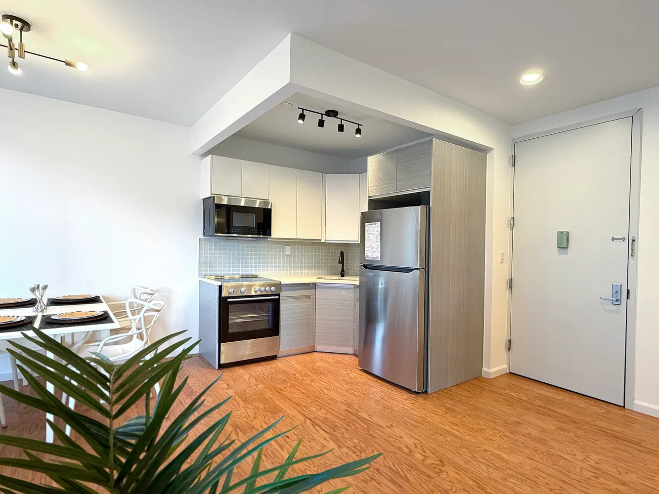 a kitchen with stainless steel appliances granite countertop a refrigerator and a stove top oven
