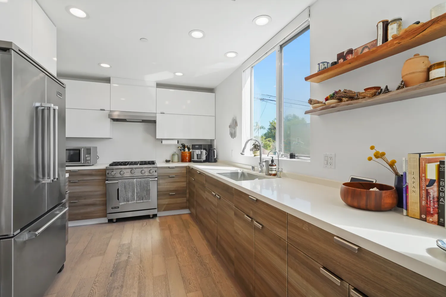 a kitchen with granite countertop a sink appliances cabinets and counter space
