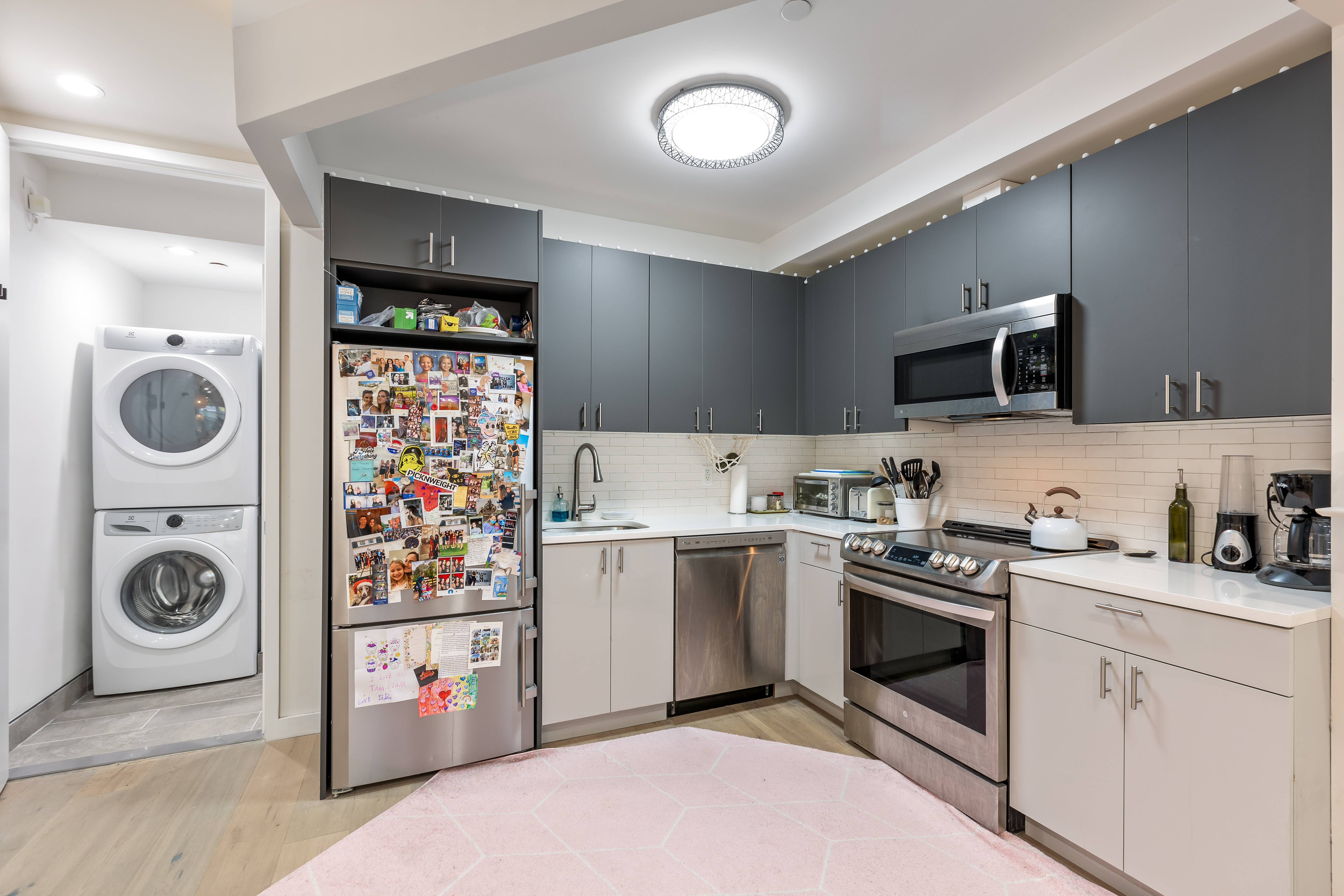 1390 Putnam Avenue, Unit 1F Brooklyn, NY 11221 - Photo 4 of 9 a kitchen with stainless steel appliances granite countertop a sink a stove a microwave and cabinets