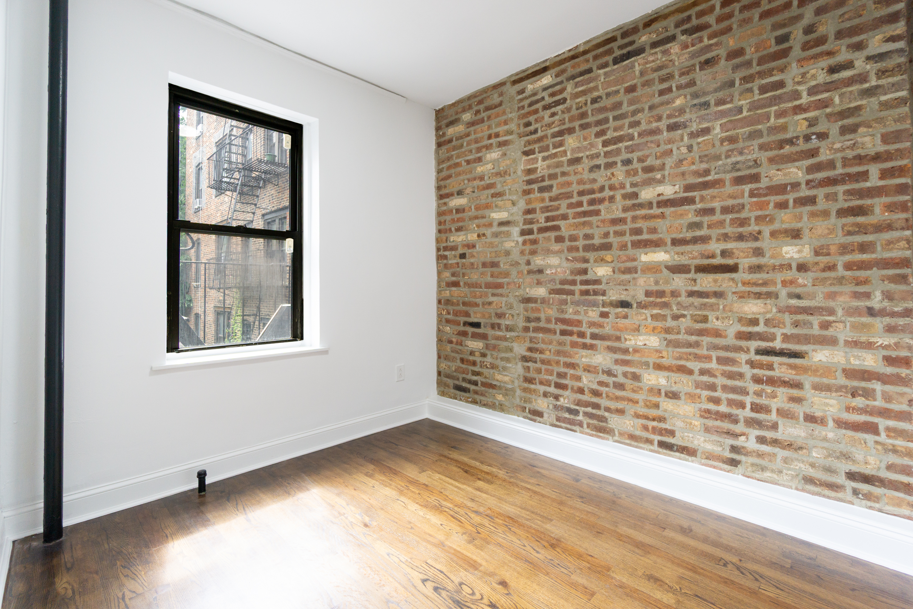 342 East 6th Street, Unit 3 Manhattan, NY 10003 - Photo 10 of 13 a view of an empty room and window