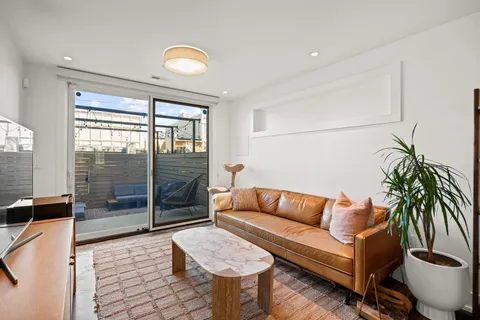 a living room with furniture and a floor to ceiling window
