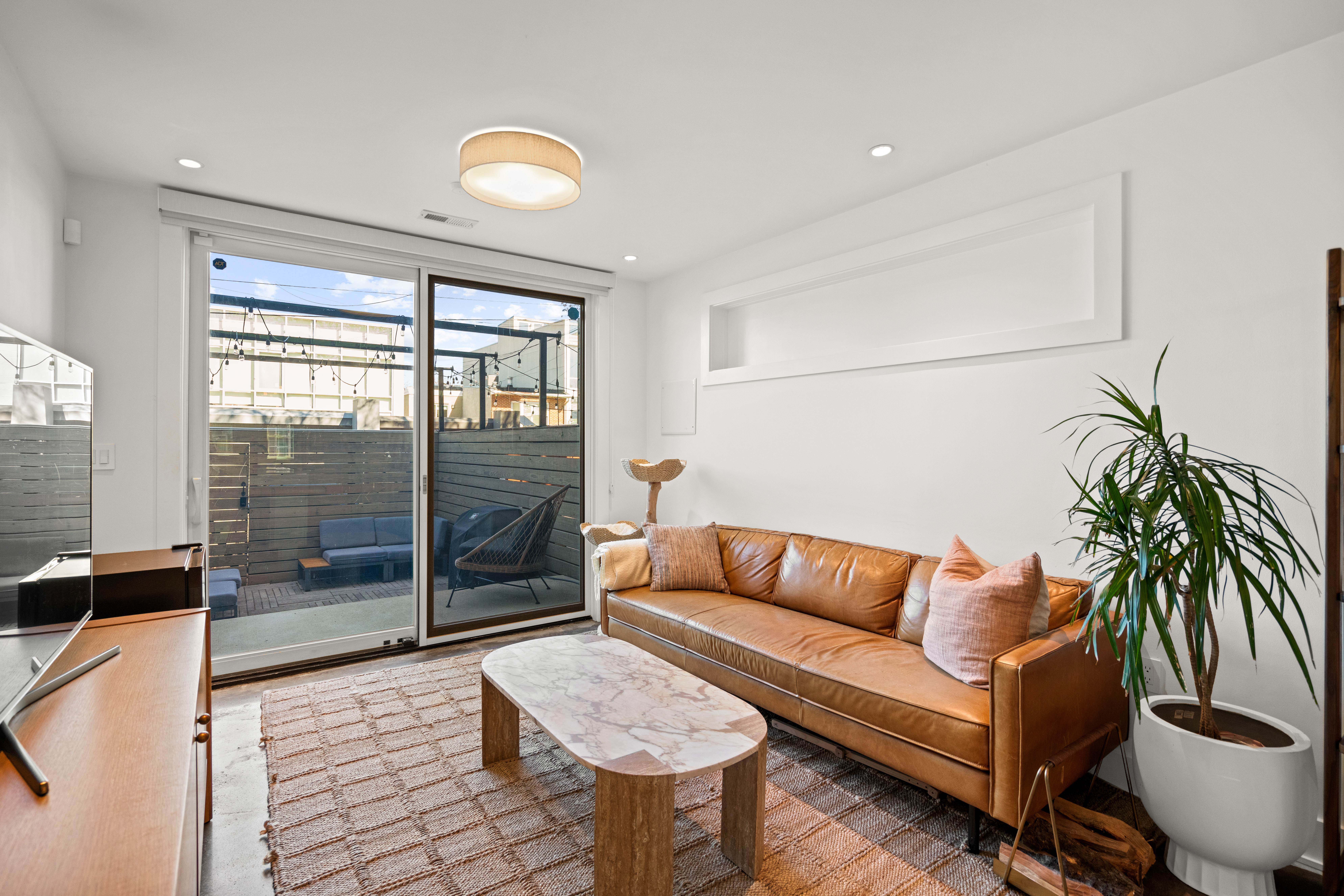 445 Ridge Street Northwest Washington, DC 20001 - Photo 17 of 43 a living room with furniture and a floor to ceiling window