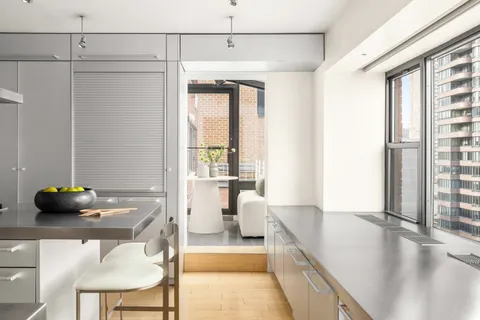 a kitchen with stainless steel appliances a sink and a refrigerator