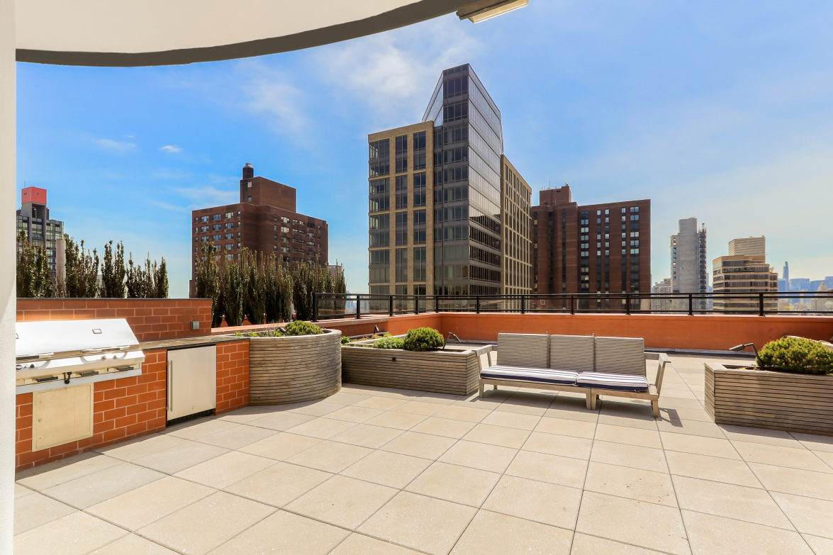 200 East 94th Street, Unit 2015 Manhattan, NY 10128 - Photo 13 of 16 a view of roof deck with a barbeque and potted plants