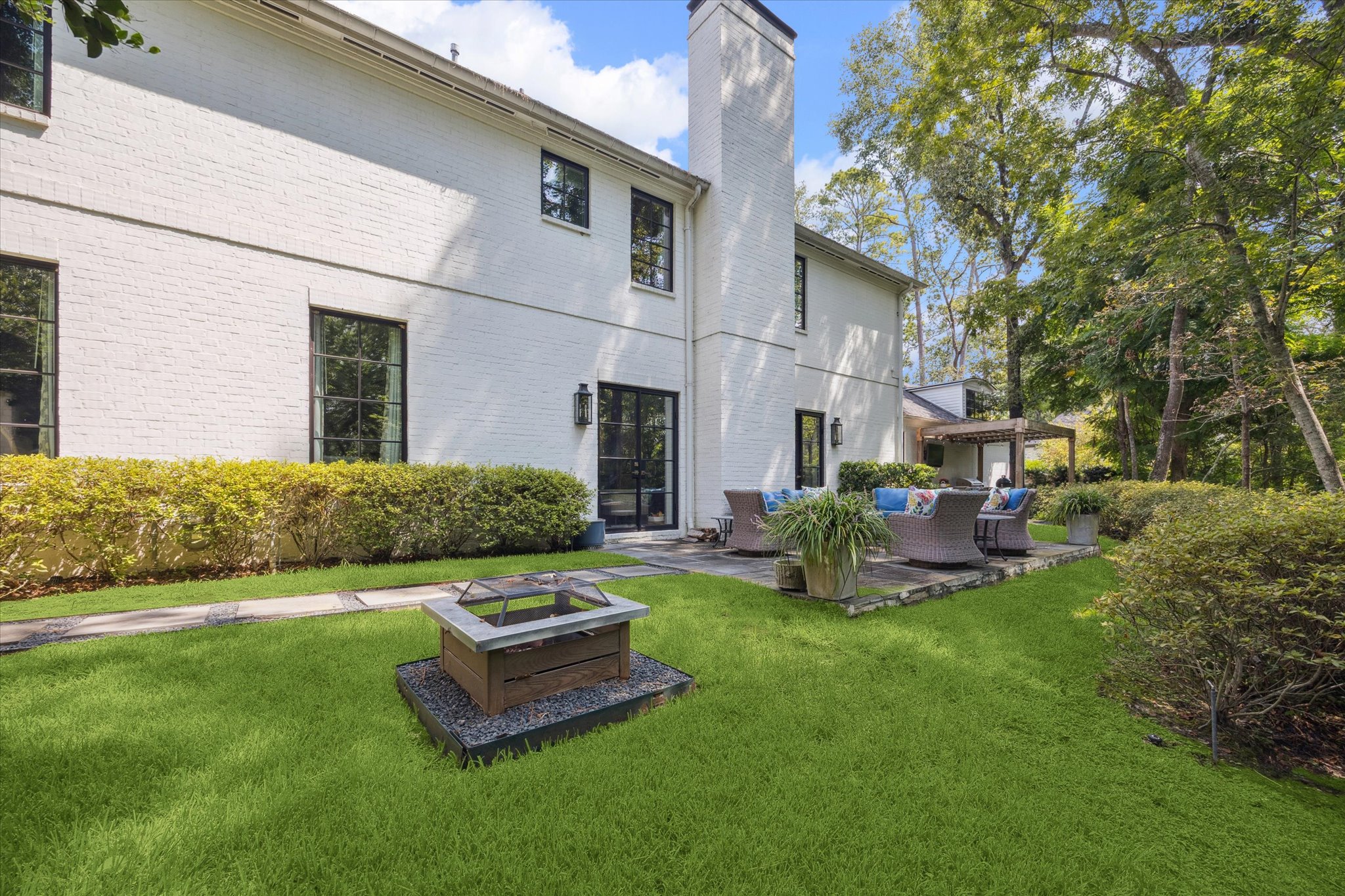 310 Longwoods Lane Houston, TX 77024 - Photo 41 of 49 a view of a house with backyard sitting area and garden