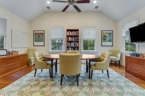 a view of a livingroom and a dining room with furniture window and wooden floor