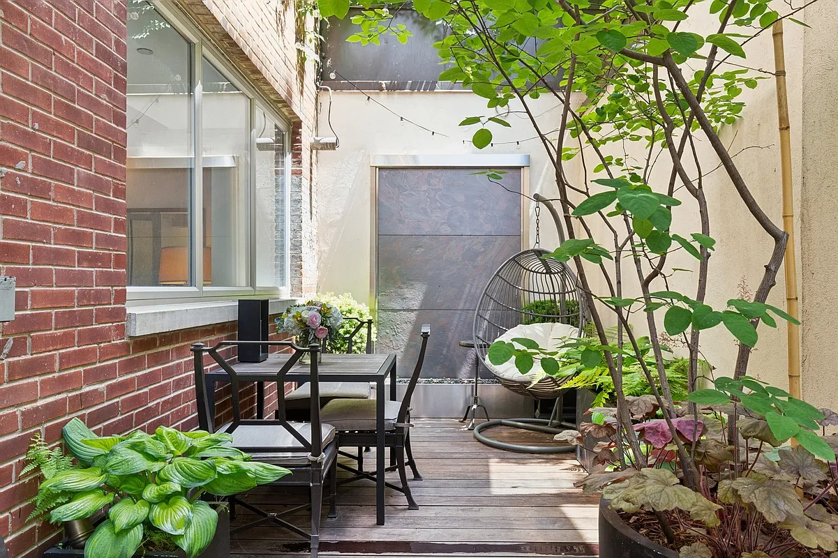 420 West 25th Street, Unit TH1E Manhattan, NY 10001 - Photo 9 of 22 a patio with table and chairs and potted plants