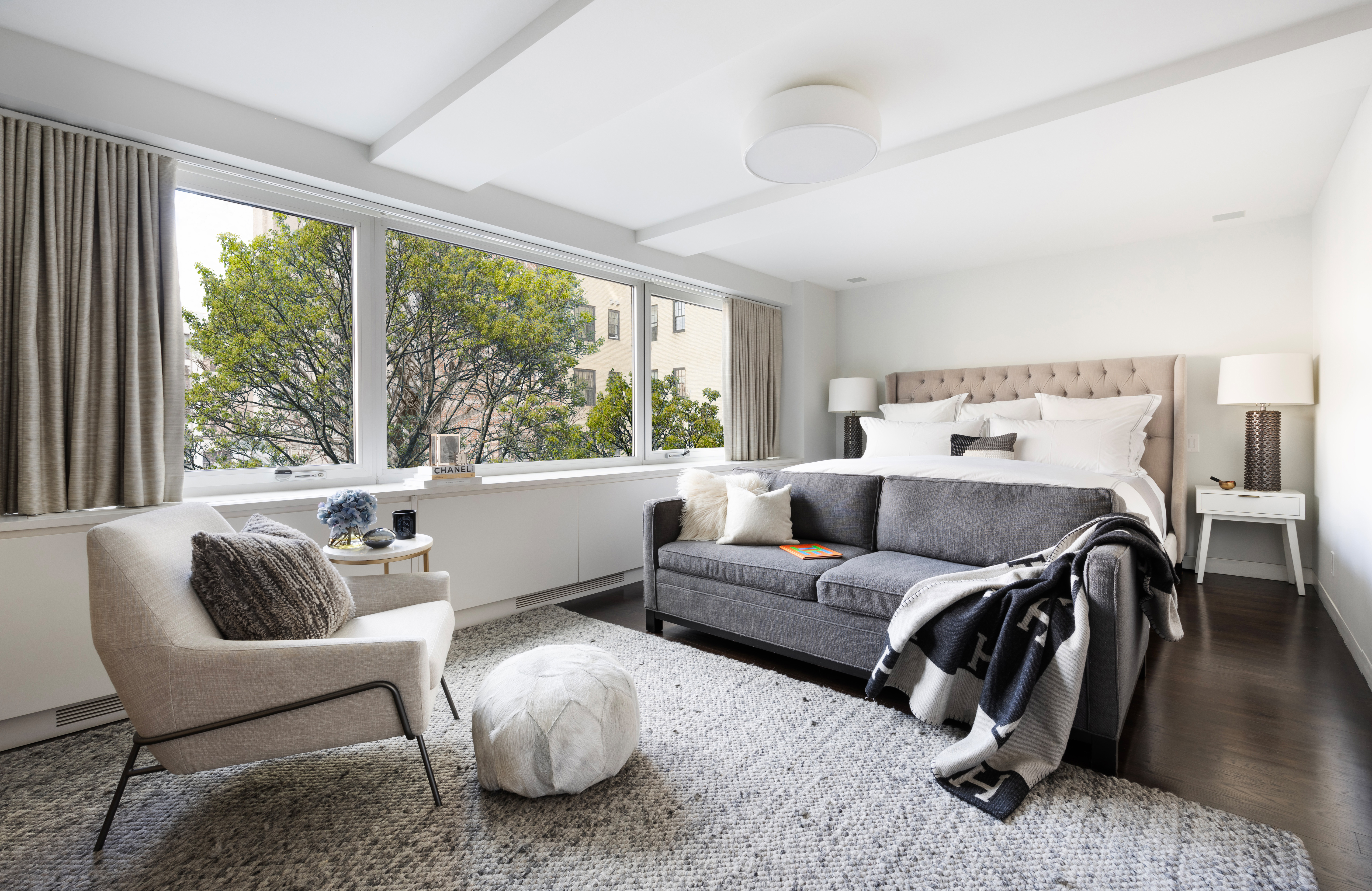 45 East 72nd Street, Unit 9BC Manhattan, NY 10021 - Photo 7 of 16 a living room with furniture and a large window