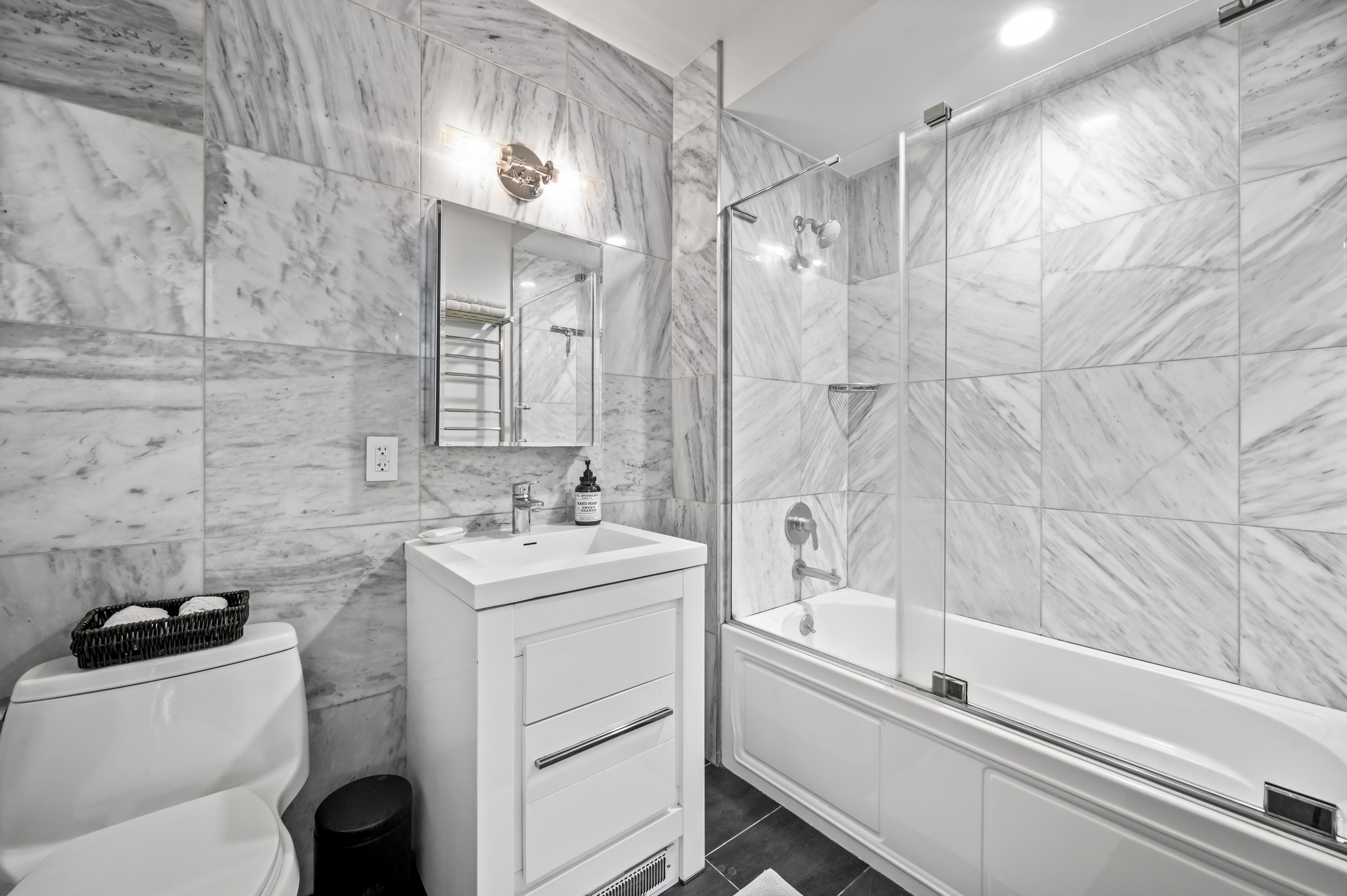58 West 129th Street, Unit 5A Manhattan, NY 10027 - Photo 6 of 7 a bathroom with a sink a toilet and a bathtub