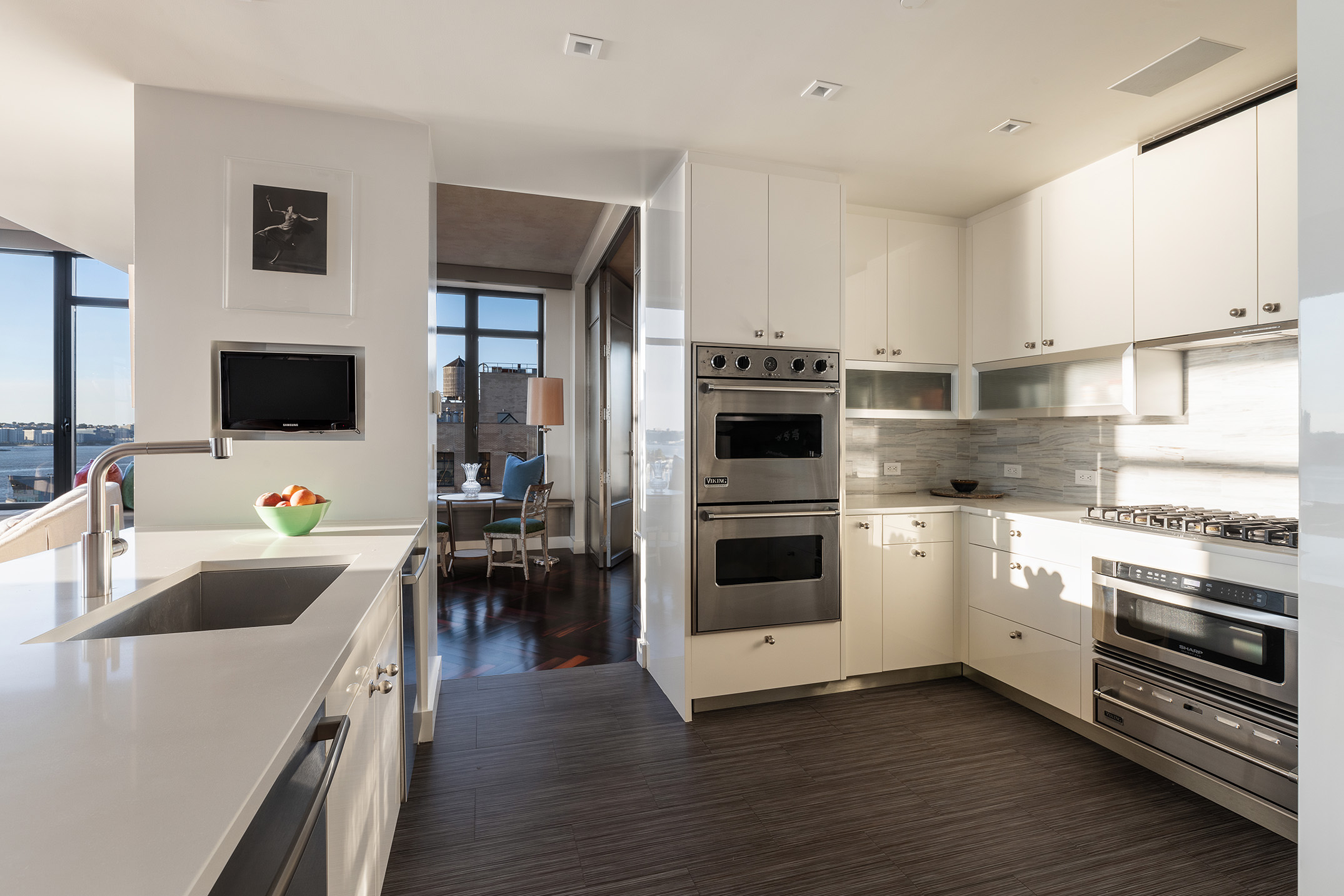 400 West 12th Street, Unit 12C Manhattan, NY 10014 - Photo 9 of 24 a kitchen with a sink white cabinets and stainless steel appliances