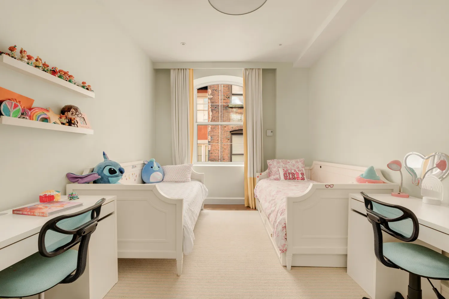 a living room with furniture a baby crib and a table