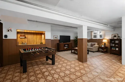 a living room with furniture window and a flat screen tv