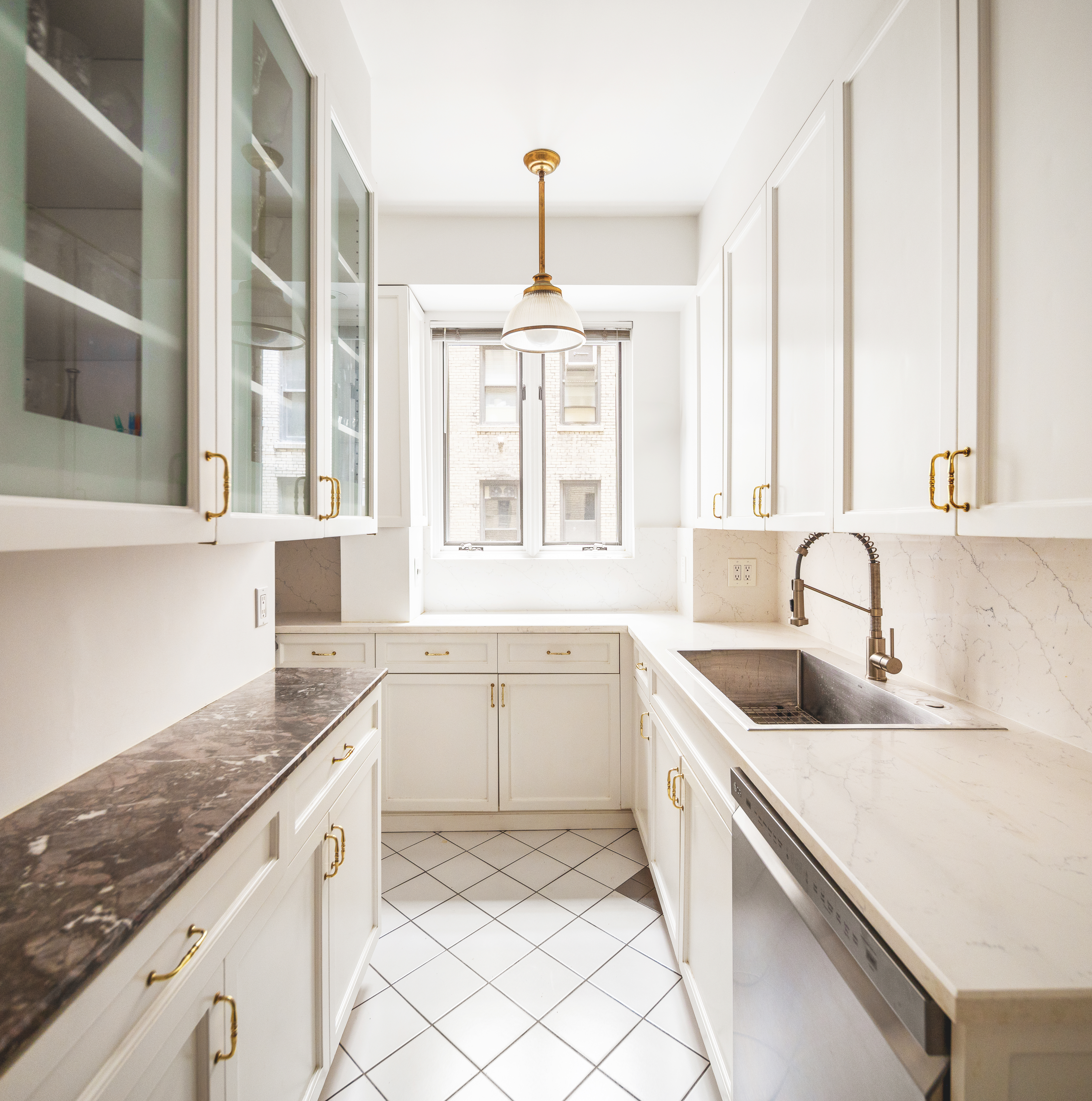 330 West 72nd Street, Unit 7A Manhattan, NY 10023 - Photo 6 of 10 a kitchen with granite countertop white cabinets and a sink