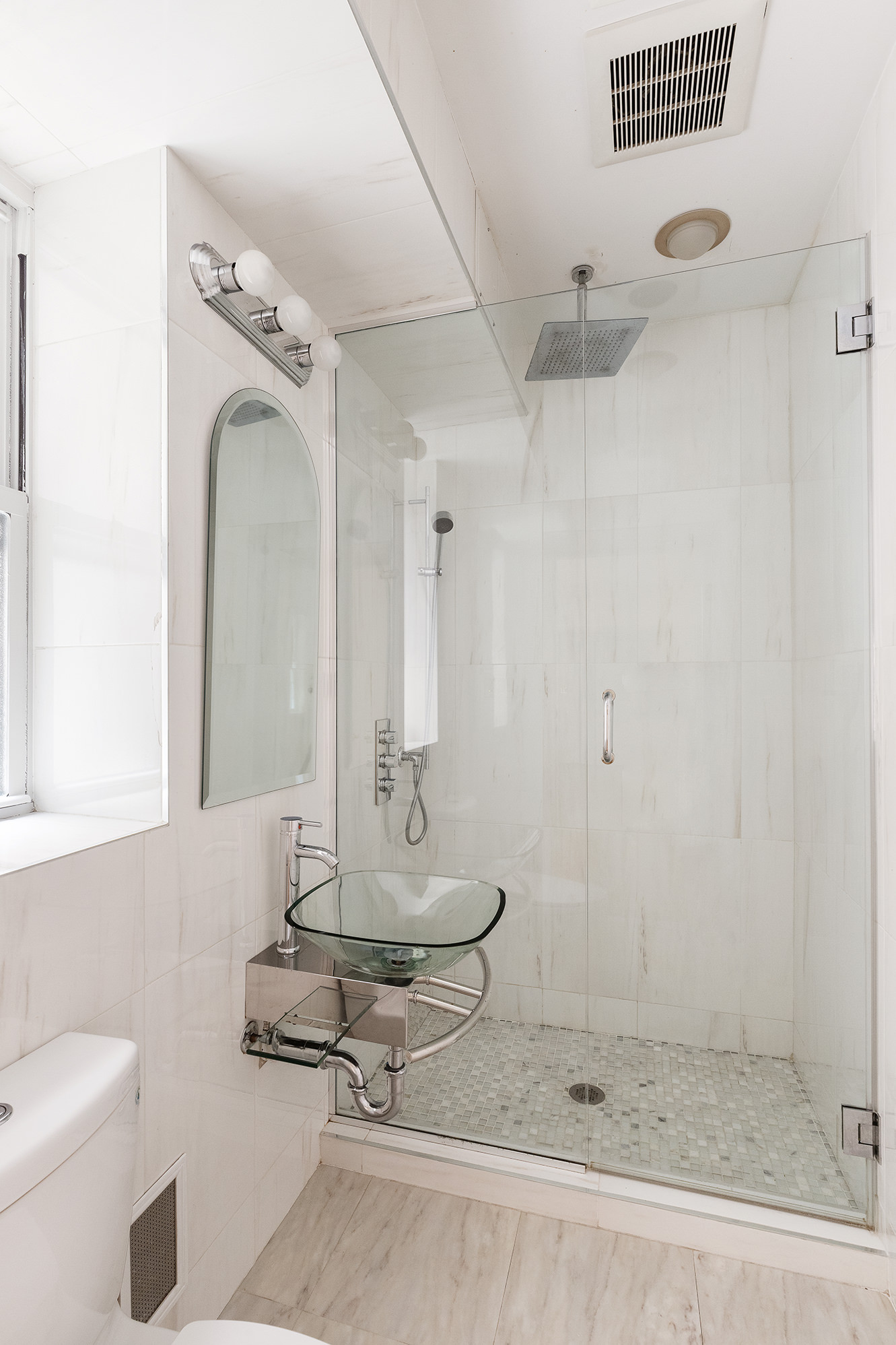 23 East 81st Street, Unit 1 Manhattan, NY 10028 - Photo 4 of 23 a bathroom with a granite countertop sink a mirror and shower