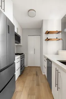 a kitchen with a refrigerator and a stove