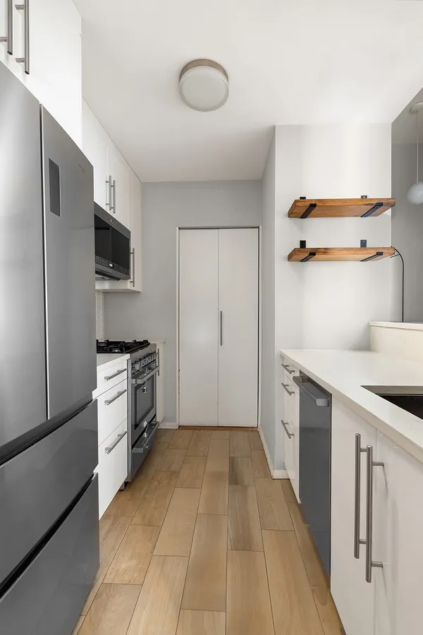 a kitchen with a refrigerator and a stove