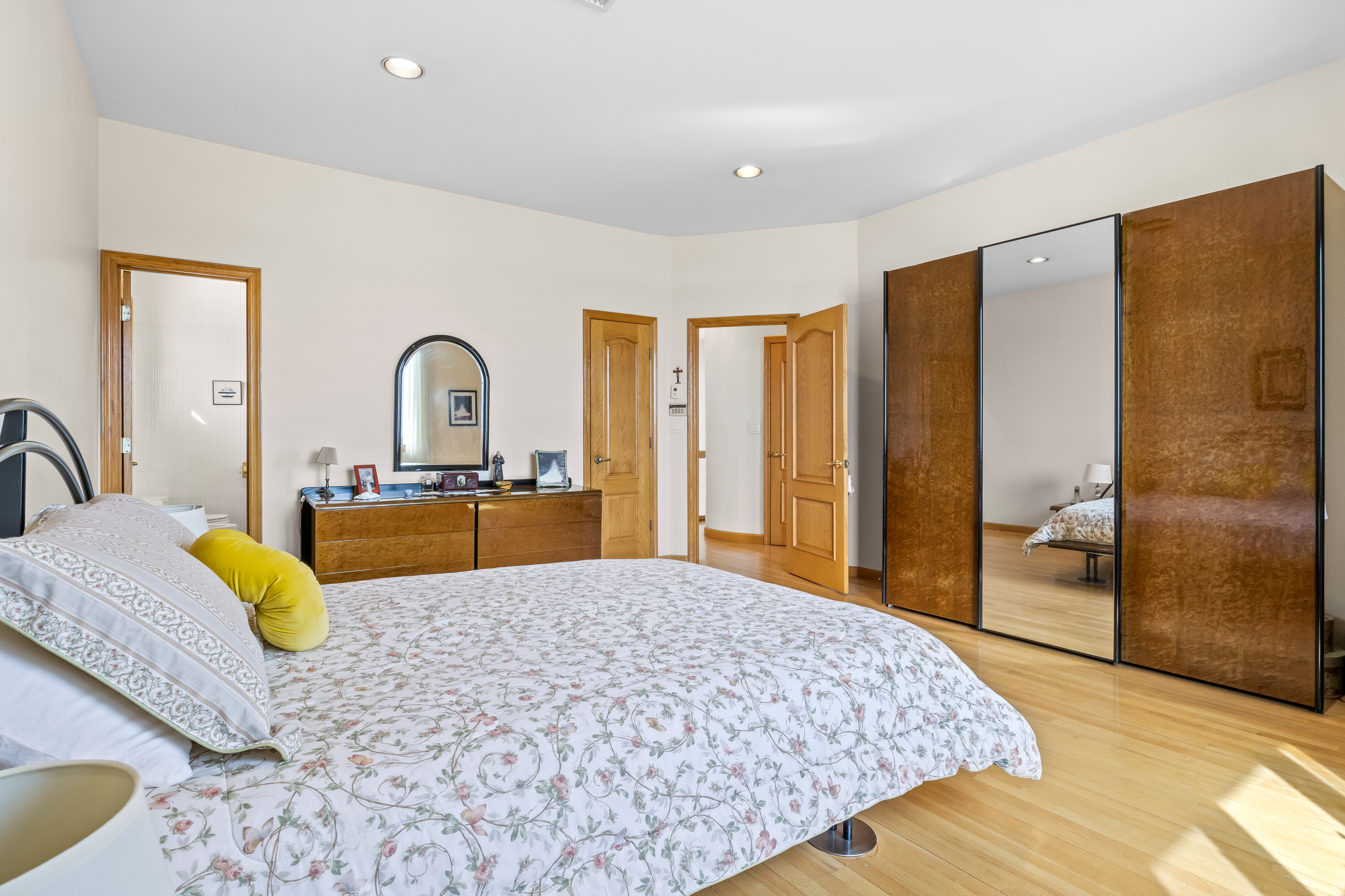 303 Whitman Drive Brooklyn, NY 11234 - Photo 18 of 37 a bed sitting in a spacious bedroom next to a bathroom with sink a bathtub and next to a window