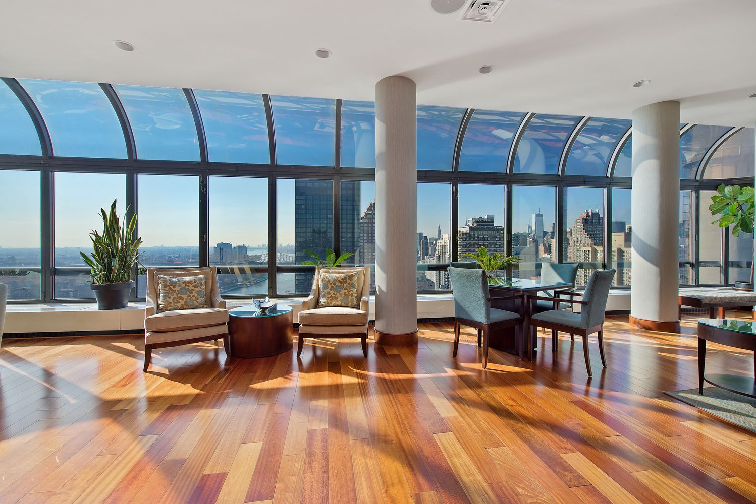 530 East 76th Street, Unit 10H Manhattan, NY 10021 - Photo 17 of 26 a living room with furniture large windows and wooden floor