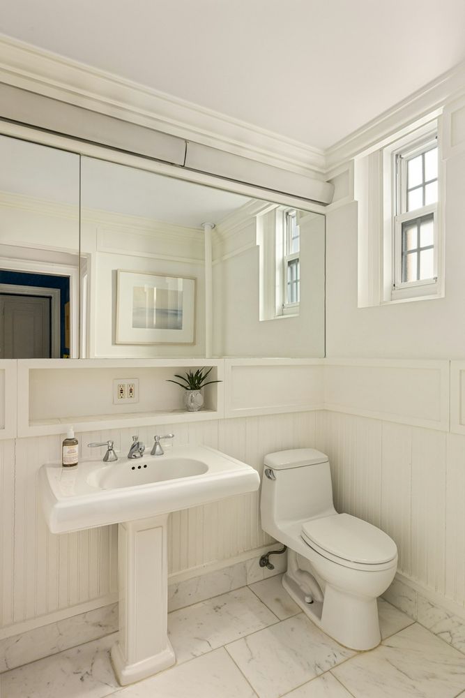 a bathroom with a sink a toilet and mirror
