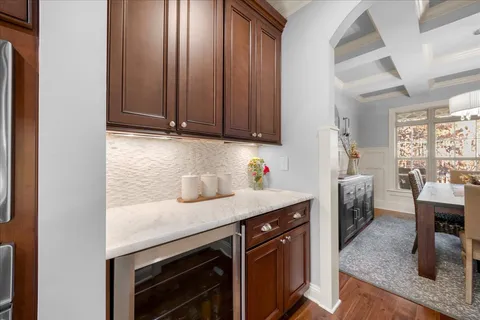 an empty room with wooden floor and entrance