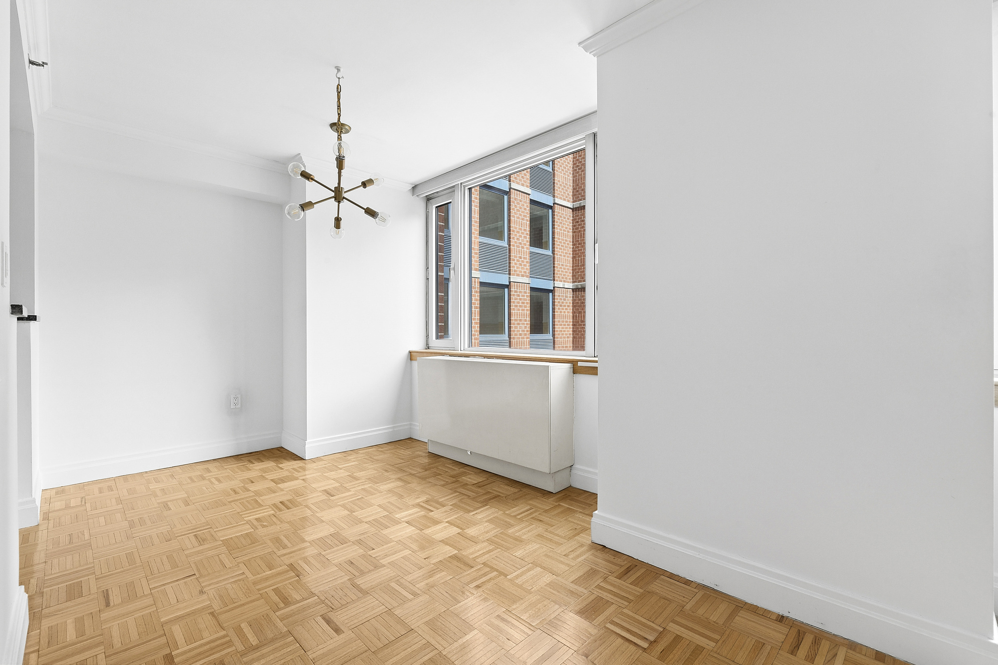 404 East 76th Street, Unit 4E Manhattan, NY 10021 - Photo 2 of 6 a view of an empty room with a window