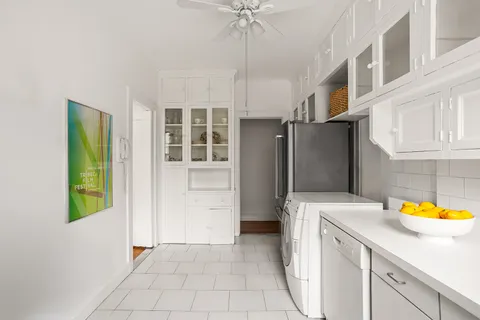a kitchen with stainless steel appliances granite countertop a refrigerator a sink and a stove