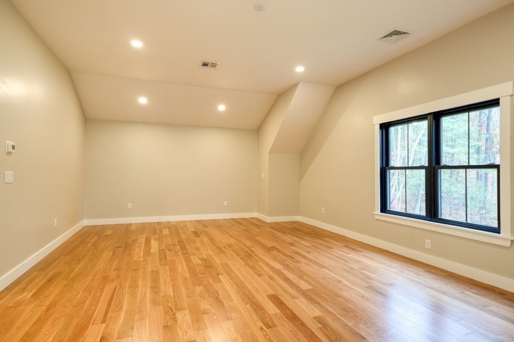 171 Randall Road Berlin, MA 01503 - Photo 22 of 41 a view of an empty room with wooden floor and a window