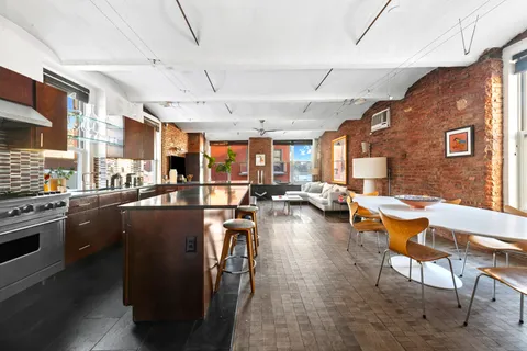a kitchen with lots of counter top space and stainless steel appliances