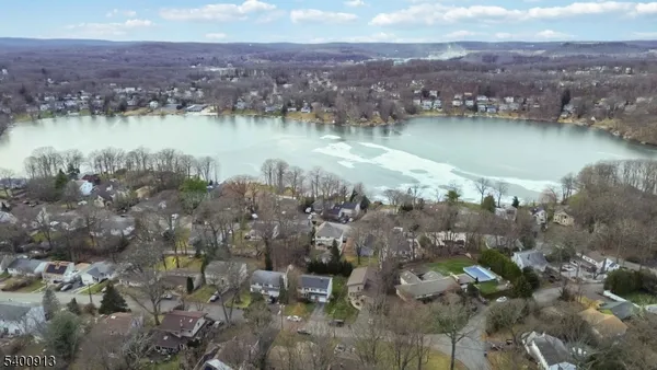 an aerial view of a houses with a lake