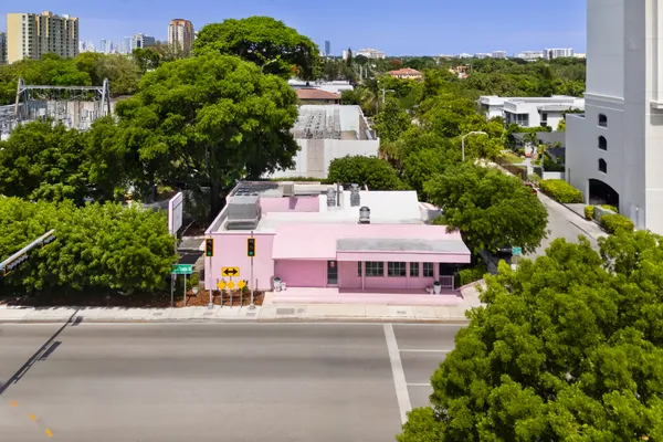 an aerial view of multiple houses with a yard