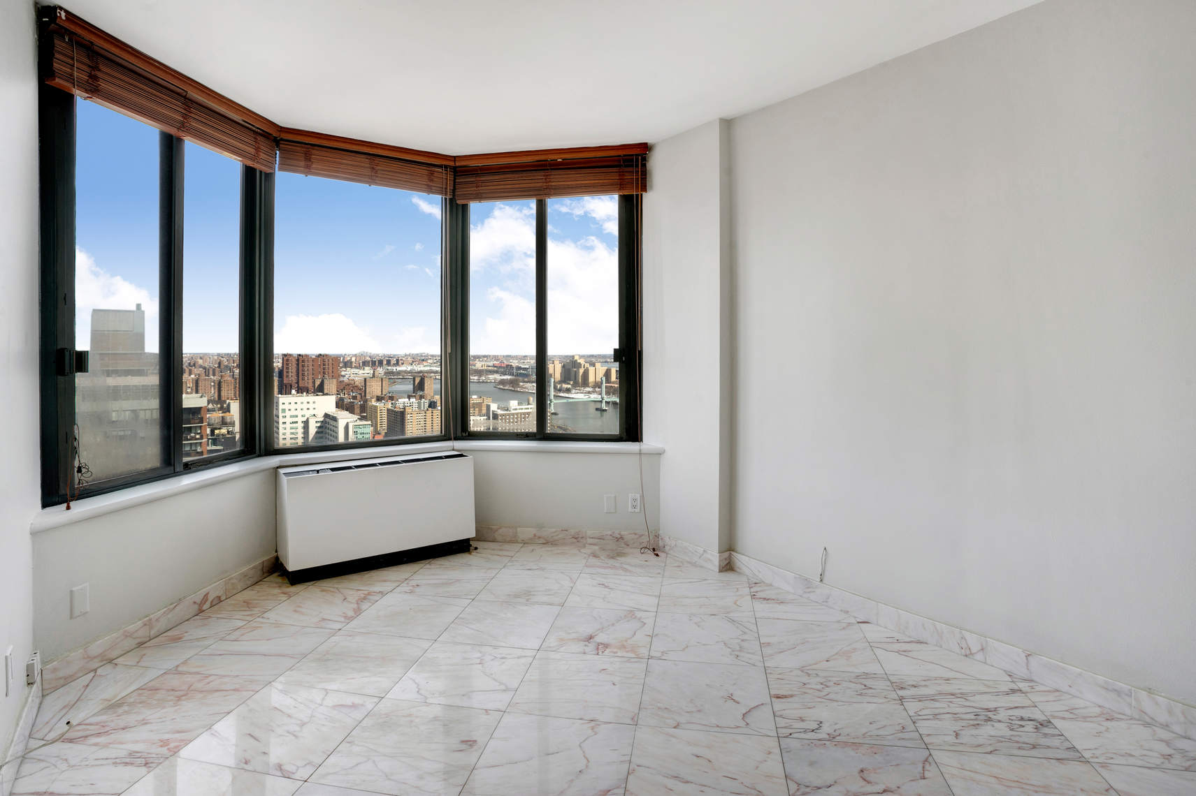 300 East 93rd Street, Unit 35D Manhattan, NY 10128 - Photo 10 of 13 a view of an empty room with a window