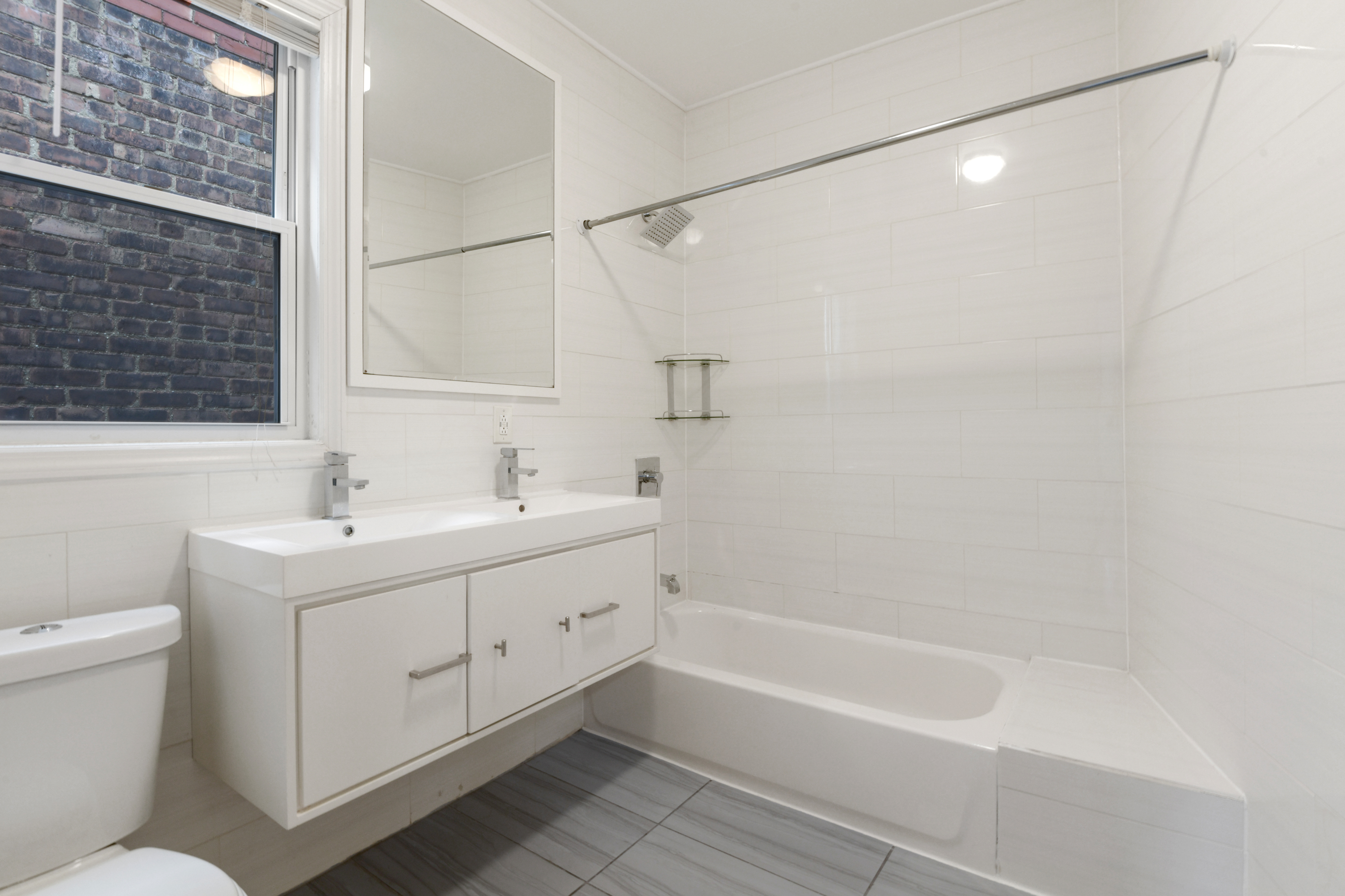332 East 198th Street, Unit 2 Bronx, NY 10458 - Photo 7 of 10 a bathroom with a sink toilet and shower