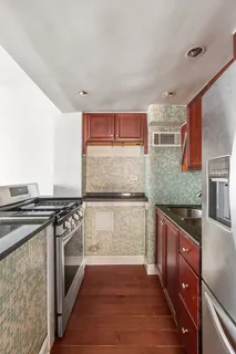 a kitchen with stainless steel appliances granite countertop a stove and a sink