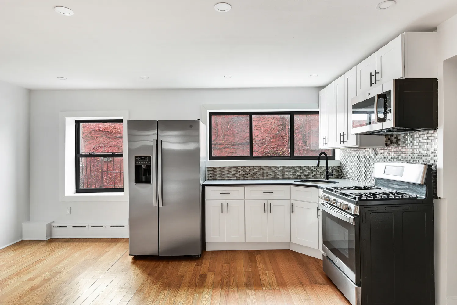 a kitchen with stainless steel appliances granite countertop a stove a sink and a refrigerator