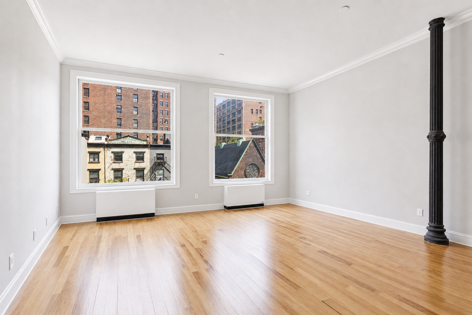 655 6th Avenue, Unit 3D Manhattan, NY 10010 - Photo 4 of 20 a view of an empty room with a window and wooden floor