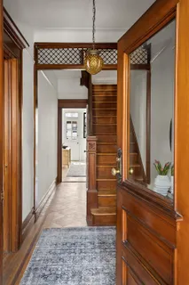 a view of a hallway with wooden floor and windows